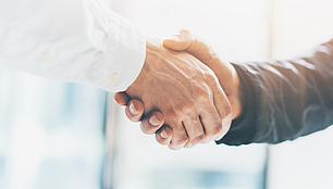 International Coordination - Frequency Planning and ITU Support Handshake between two business people representing international coordination in frequency planning and ITU processes