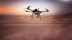 Drone-based airborne monitoring unit for military spectrum monitoring above desert terrain.