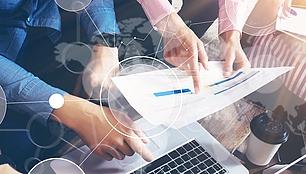 Hands review technical plans and data, representing consulting for efficient spectrum and network projects.